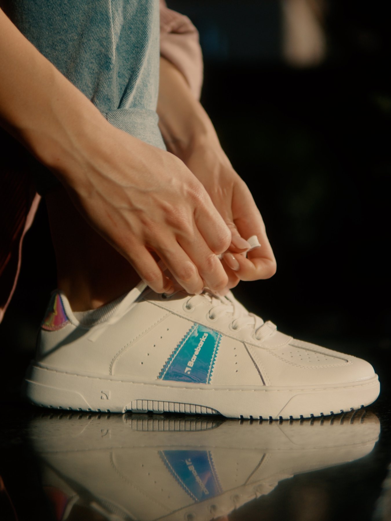A clean white sneaker that cat