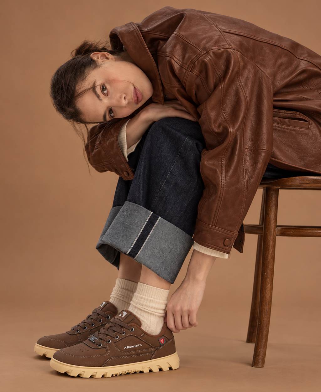 Barefoot shoes Barebarics - model sitting on a wooden chair