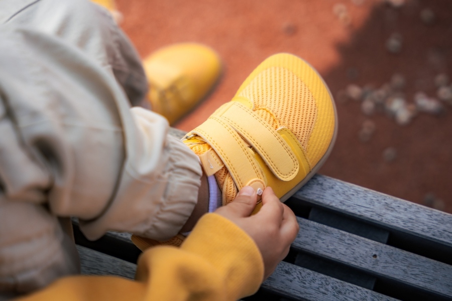 Fastening kids' barefoot shoes with a velcro strap Fastening kids' barefoot shoes with a velcro strap