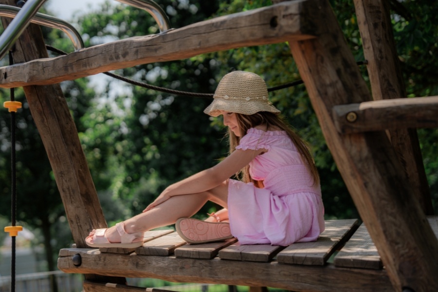 Putting on kids' barefoot sandals outdoors Putting on kids' barefoot sandals outdoors