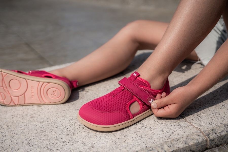 Fastening kids' barefoot sandals with a velcro strap Fastening kids' barefoot sandals with a velcro strap