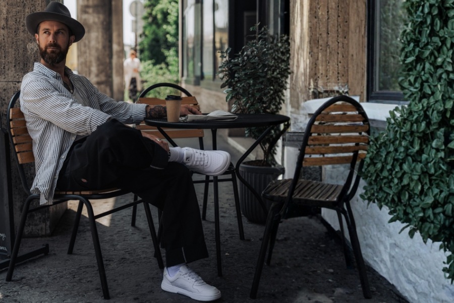 Men's Barebarics barefoot sneakers at a sidewalk cafe