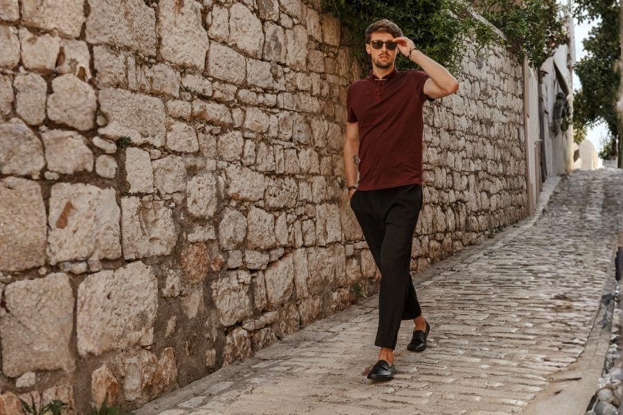 Men's barefoot loafers worn on a cobblestone street Men's barefoot loafers worn on a cobblestone street