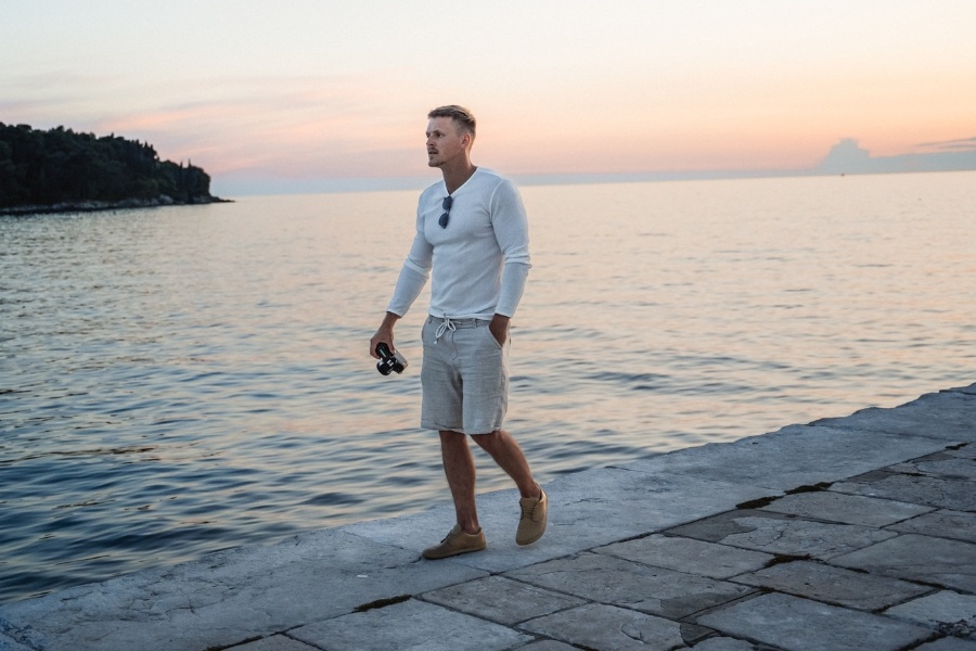 Men's barefoot dress shoes on an evening seaside walk Men's barefoot dress shoes on an evening seaside walk
